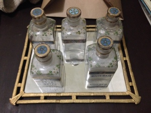 Vintage glass bottles with stoppers atop a mirrored tray make a lovely dresser or vanity set.